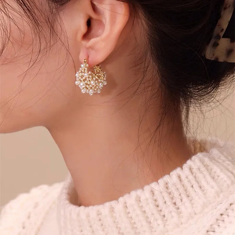 Gold copper flower basket earrings with small rice-shaped beads and pearl inlay detail