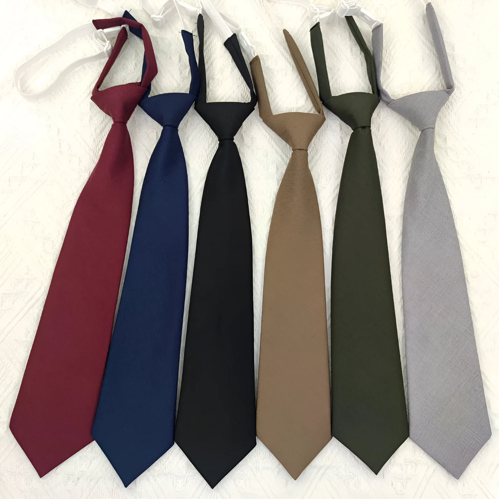 Solid colour men's cotton bow tie in arrow style laid flat, showing navy blue colour option.