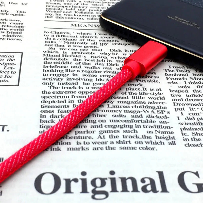 Close-up of a denim-braided USB-C cable with aluminium connectors in choice of colours.
