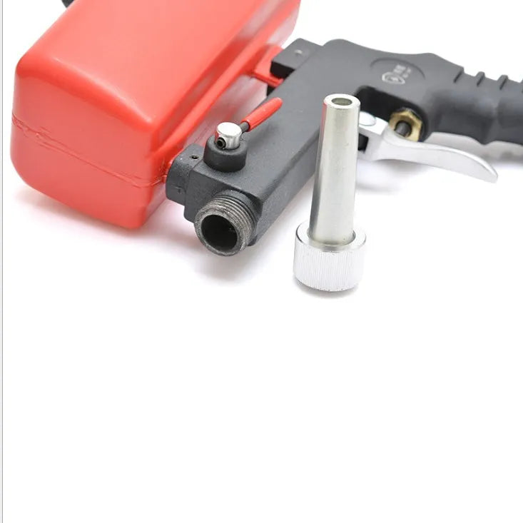 Portable black pneumatic sandblasting gun with top-mounted tank and spray nozzle.