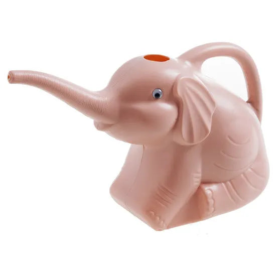 Pink baby elephant-shaped watering can with a long spout and baby bottle handle on a table.