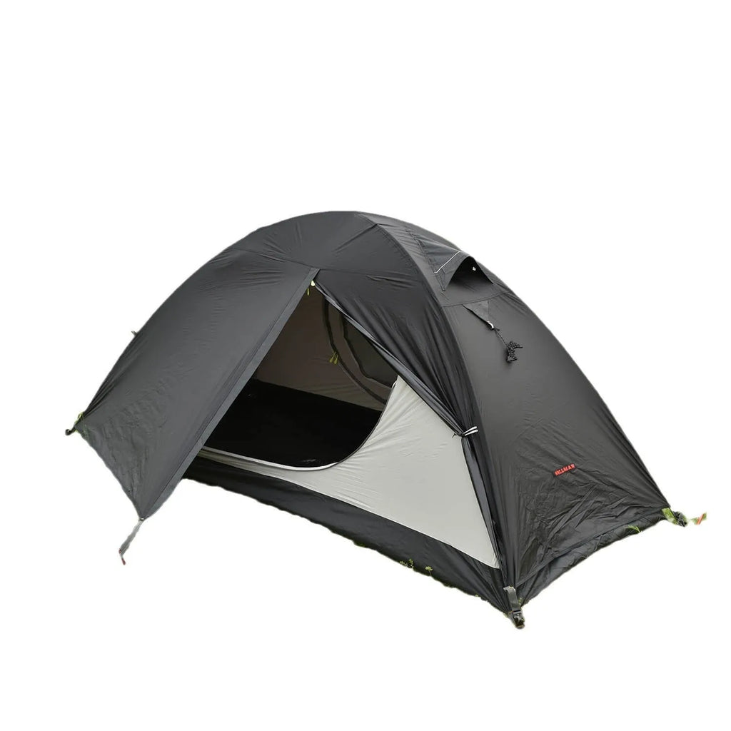 Single person orange hiking tent with aluminium poles pitched in outdoor setting