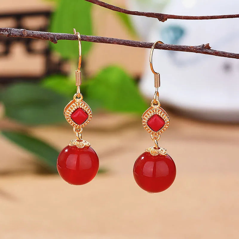 Geometric copper earrings with round red agate beads and silver jasper inlay.