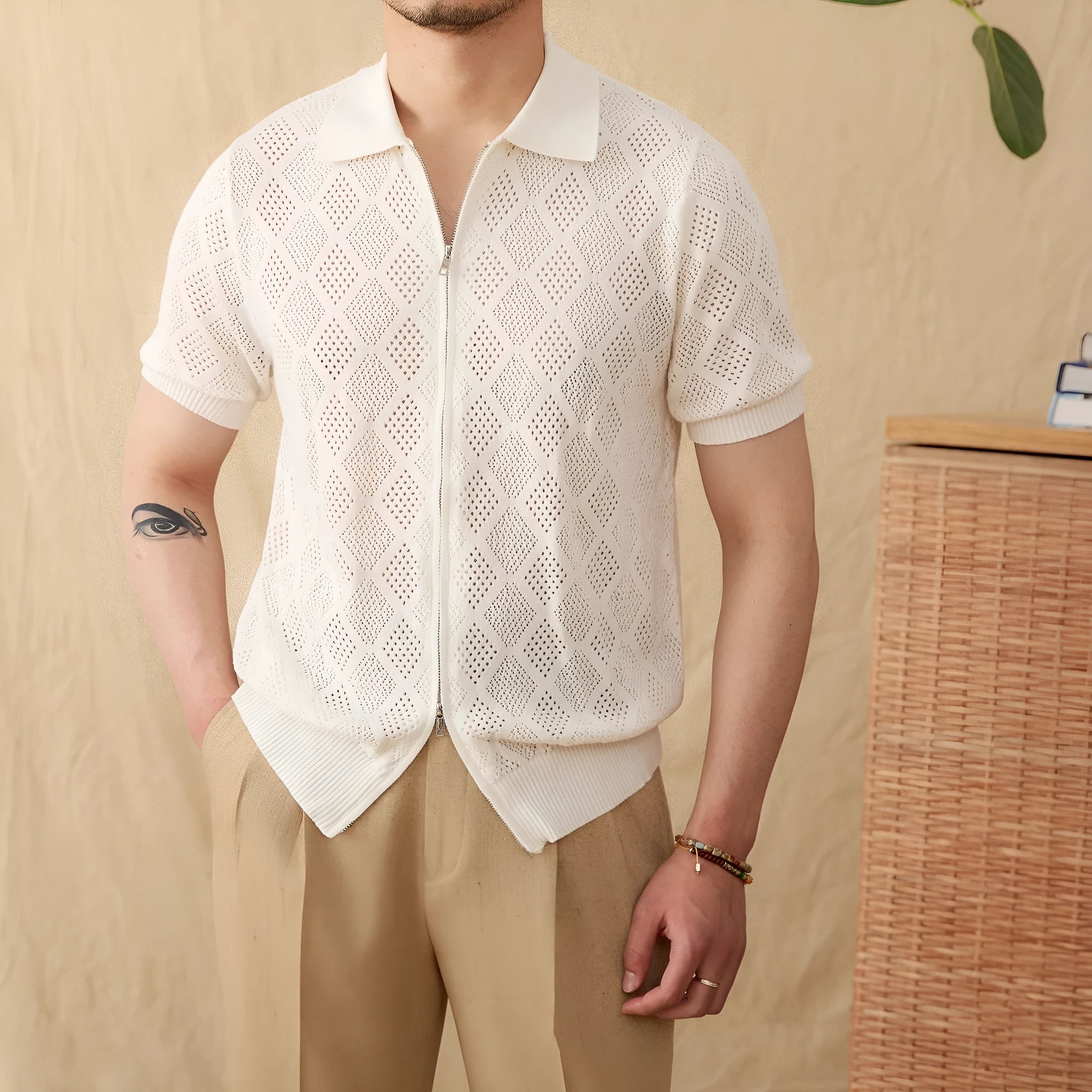 Light brown cotton cardigan with front zipper and short sleeves laid flat.