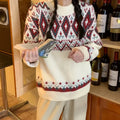 Red and white striped loose retro pullover knitted top with long sleeves on a hanger.