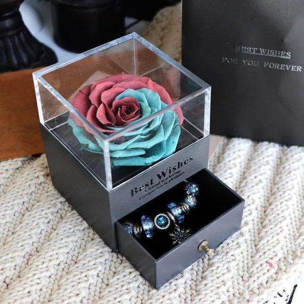 Glass eternal flower jewellery box with preserved roses and carnations inside measuring 8.5cm square