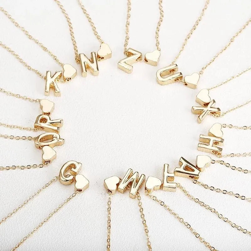 Peach-shaped heart letter pendant necklace on a chain in a gold or silver alloy finish.