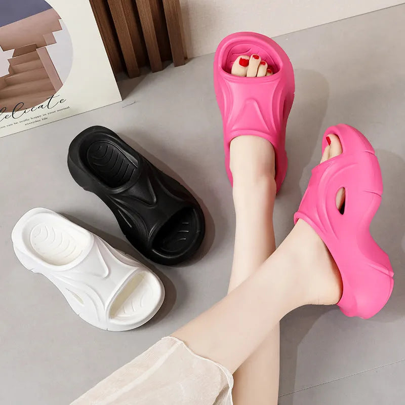 Women's thick-soled EVA beach slippers in rose red colour on a sandy background