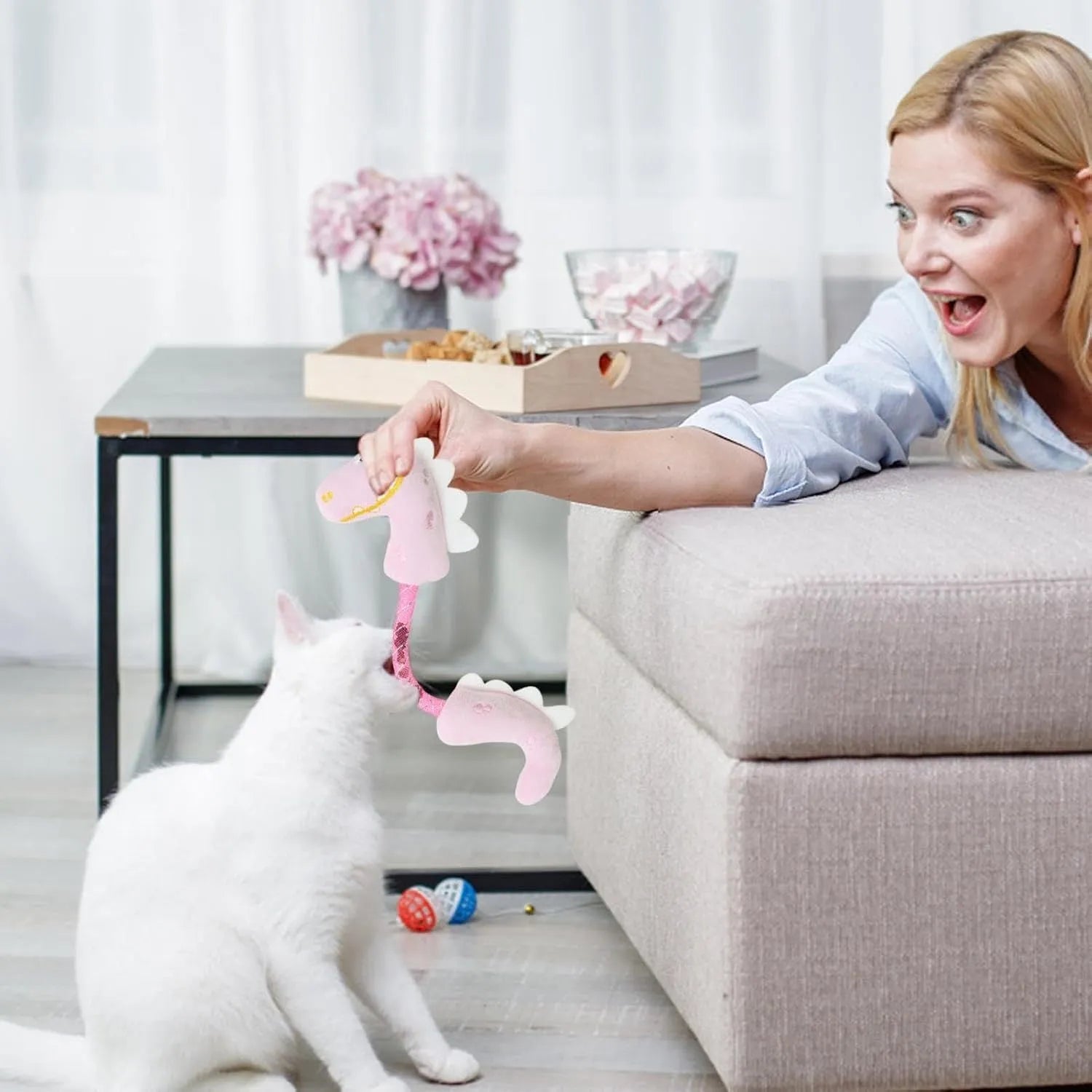 Set of four cat toys including rope, spring, and plush types in various colours
