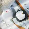 USB rechargeable electric hand warmer with penguin polar bear design showing front and back heating surfaces