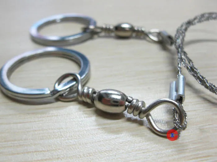 Stainless steel survival wire saw with pull rings showing 55cm cutting length
