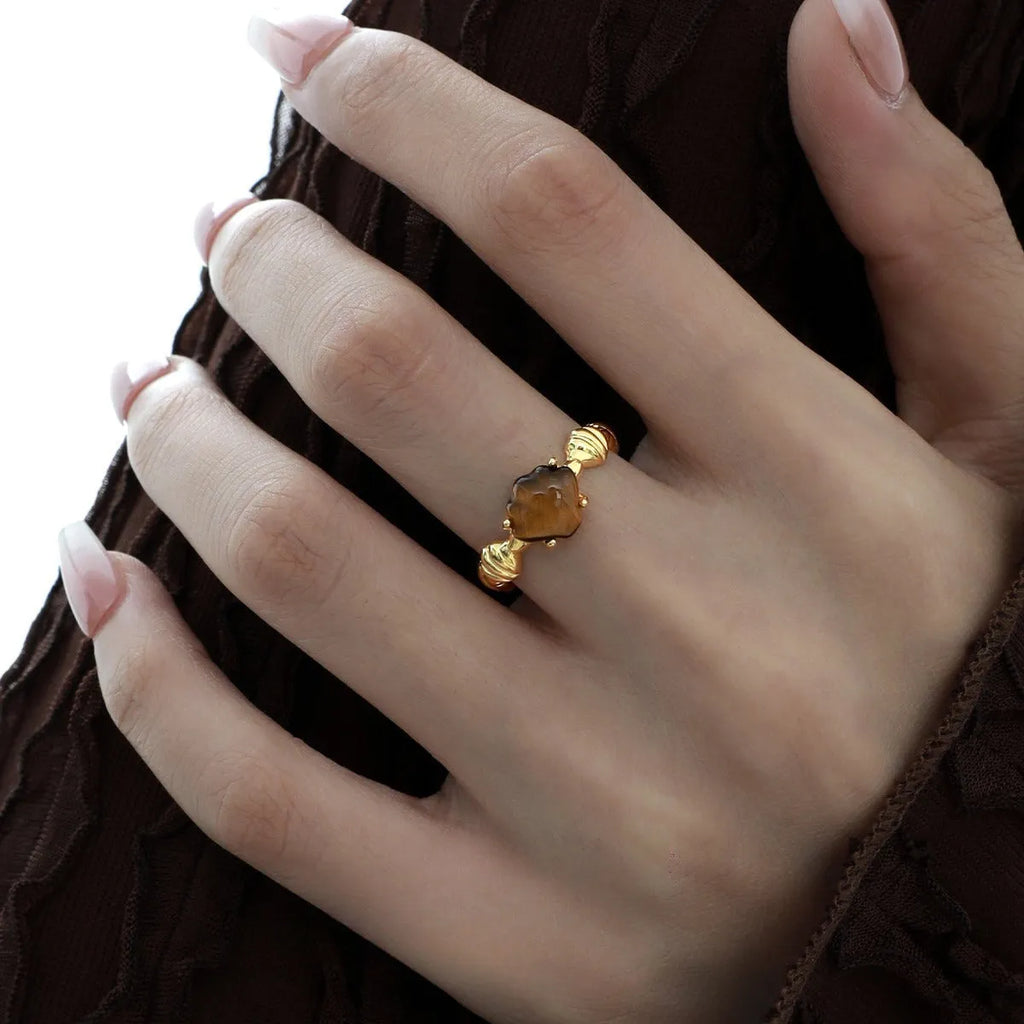 Adjustable silver ring with shell decoration and tiger eye stone on adjustable band