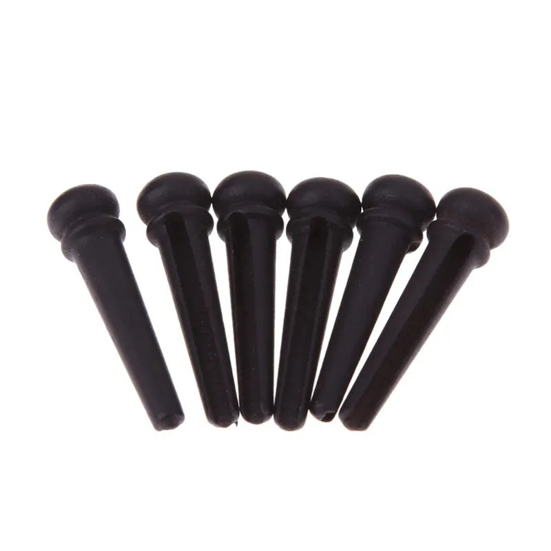 Six ebony folk guitar string nails with 5.3mm bayonet diameter and matt black finish