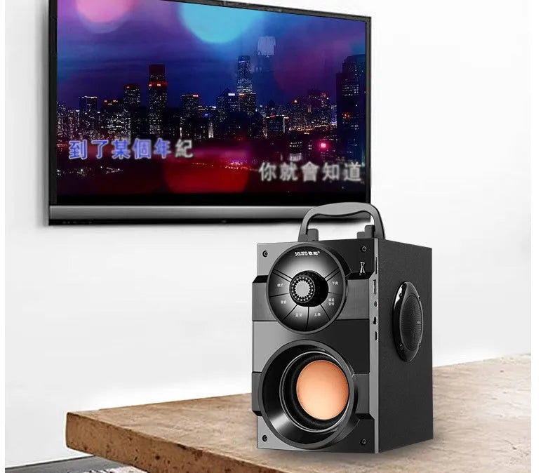 Black portable audio system with subwoofer, USB cable, and 3.5mm audio connection cable