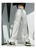 Women's slim drape trousers with contrast ribbon parallel bars detailing and loose straight leg cut
