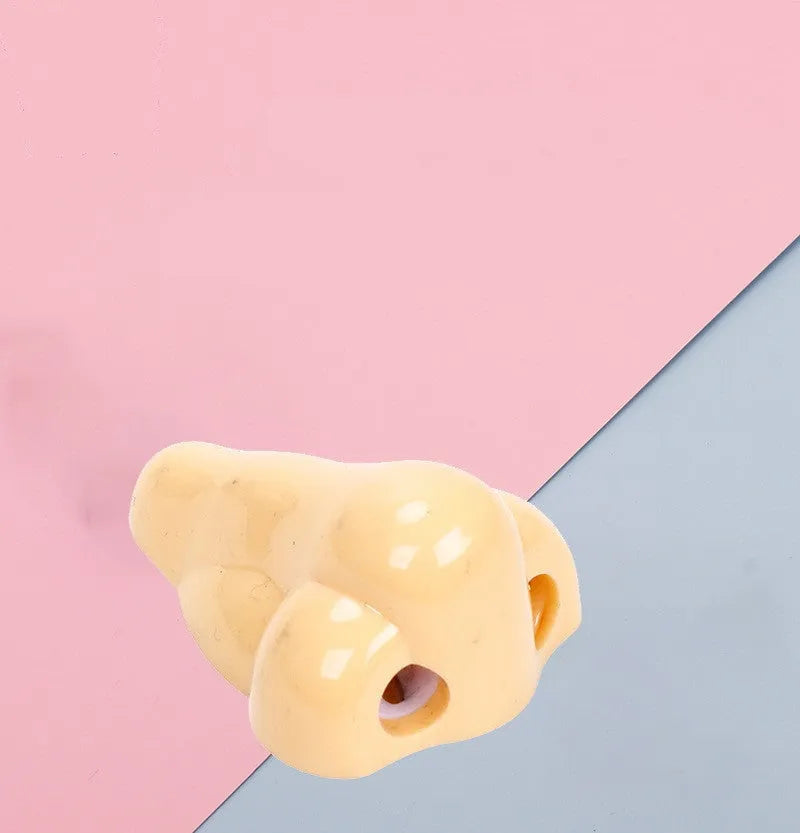 Flesh-coloured plastic pencil sharpener with dual holes for different pencil sizes