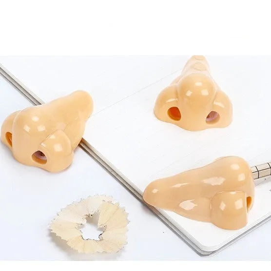 Flesh-coloured plastic pencil sharpener with dual holes for different pencil sizes