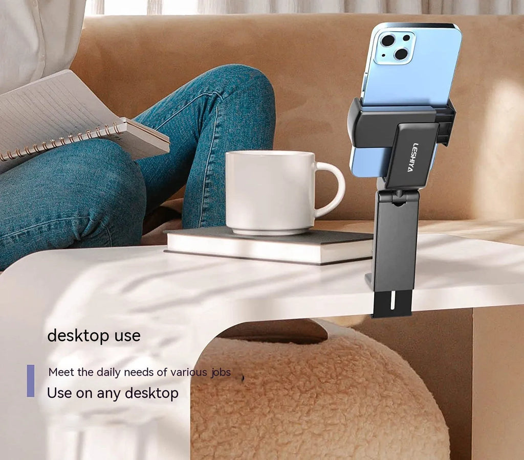 Black foldable rotating phone stand holding a mobile phone in landscape orientation on a desk.