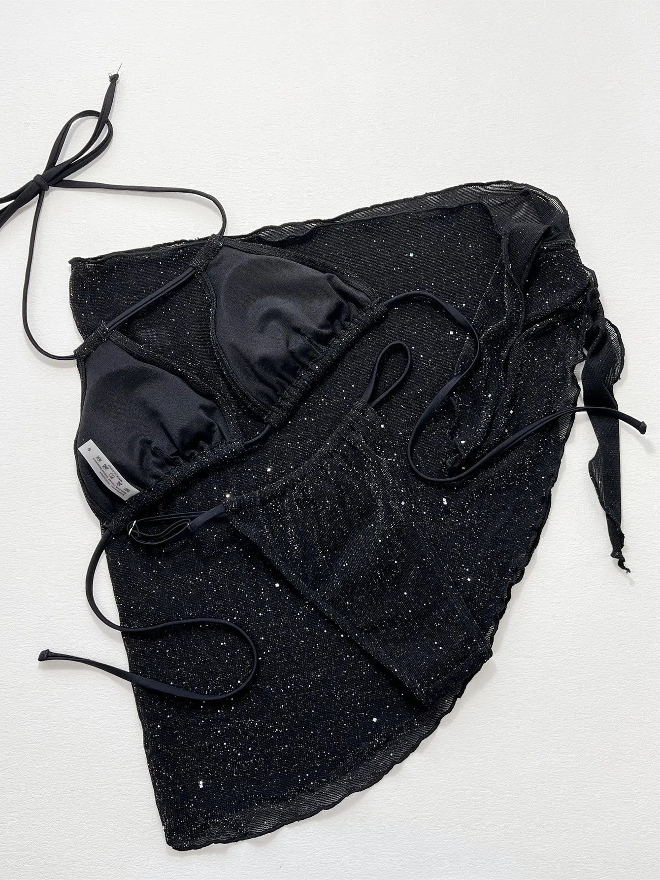 Black three-piece bikini swimsuit with matching top and shorts
