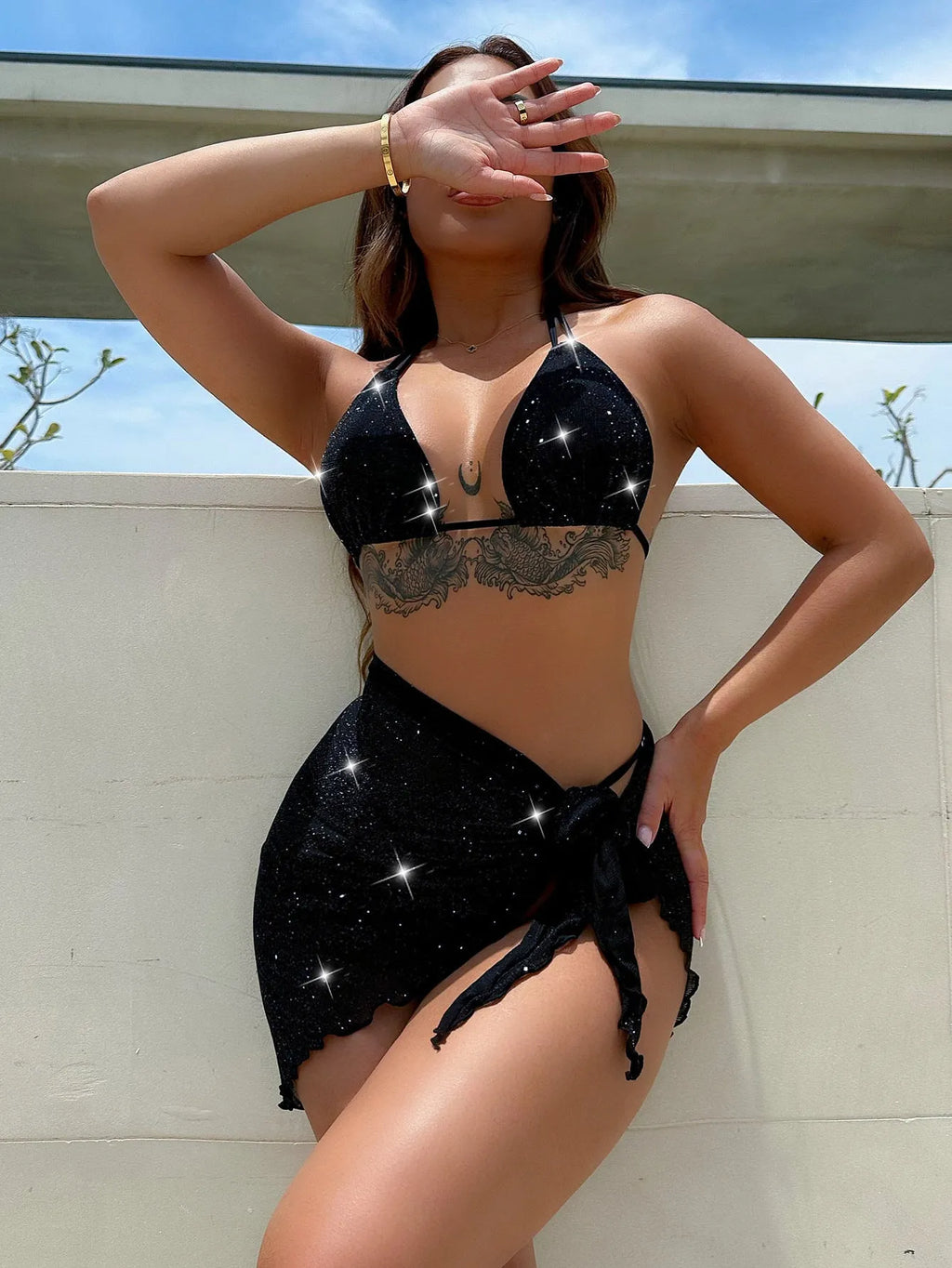 Black three-piece bikini swimsuit with matching top and shorts