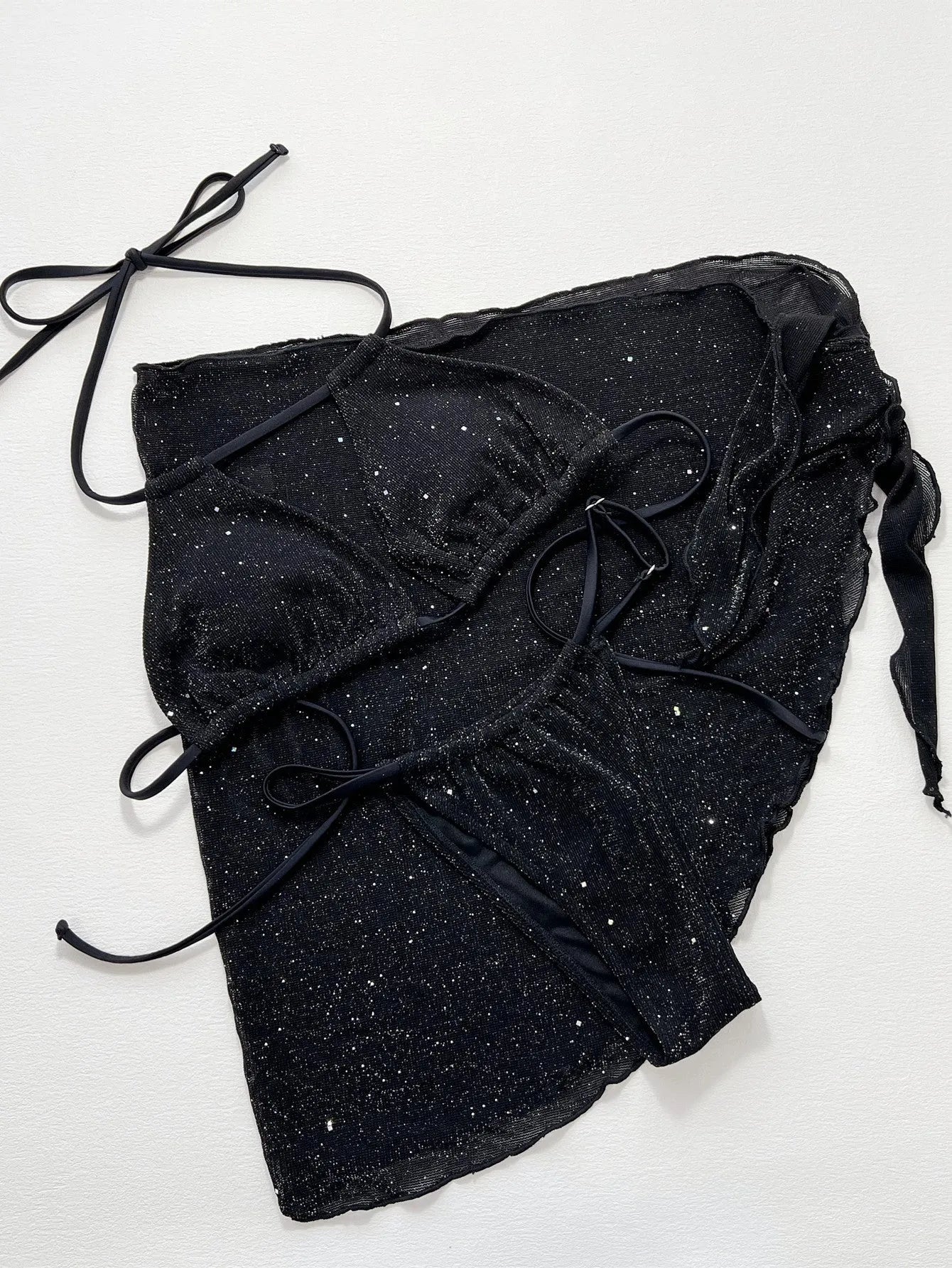 Black three-piece bikini swimsuit with matching top and shorts