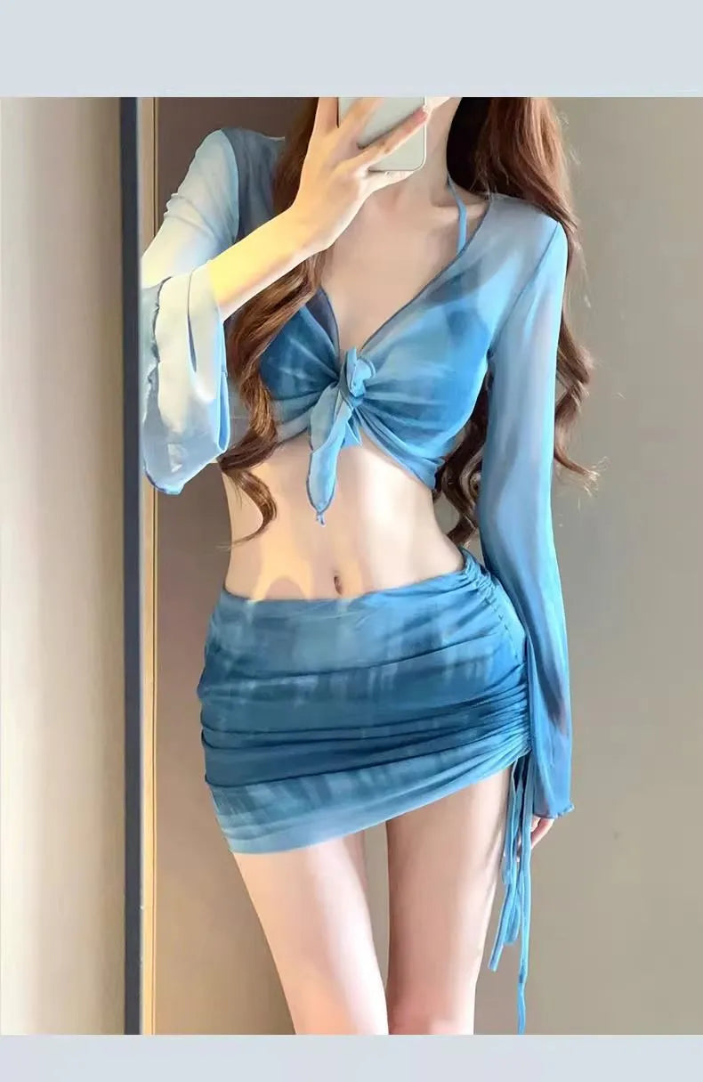 Women's blue high-waisted bikini four-piece swimsuit set showing shirt, bra, underwear and skirt components