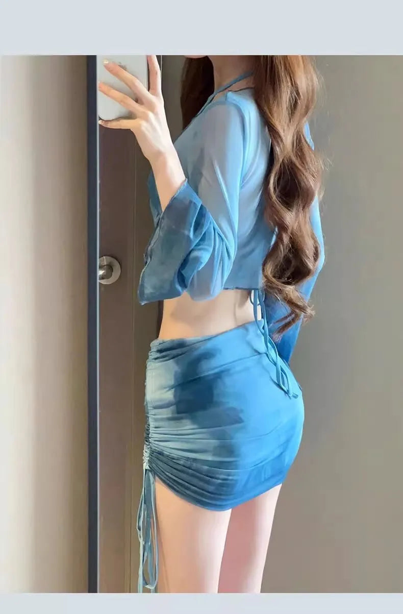 Women's blue high-waisted bikini four-piece swimsuit set showing shirt, bra, underwear and skirt components
