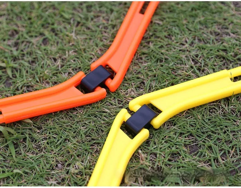 Set of six foldable yellow, green, and orange plastic hexagon football agility training rings laid out on grass.