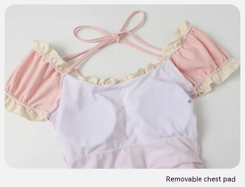 Women's pink conservative one-piece swimsuit with Siamese detailing in nylon fabric