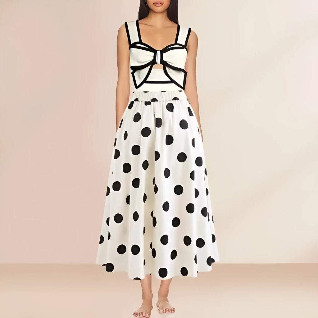 Women's black one-piece swimsuit with white round skirt and bow detail on a mannequin