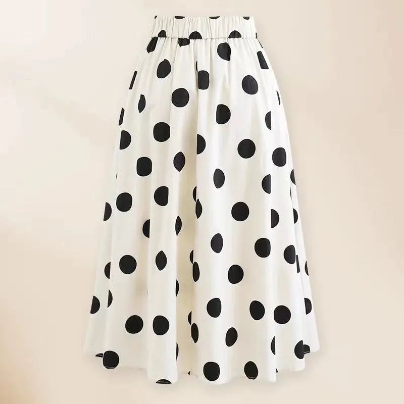 Women's black one-piece swimsuit with white round skirt and bow detail on a mannequin