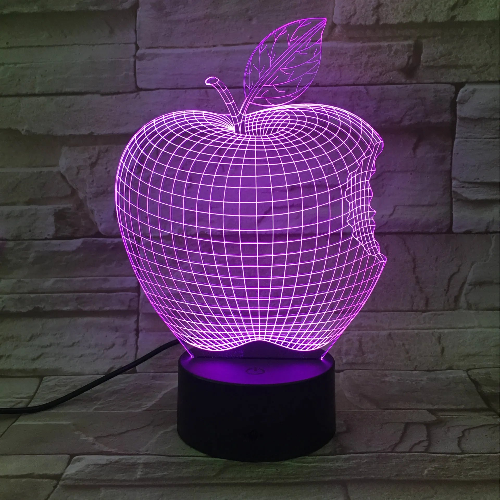 3D fruit-shaped colourful LED night light with touch control on a surface