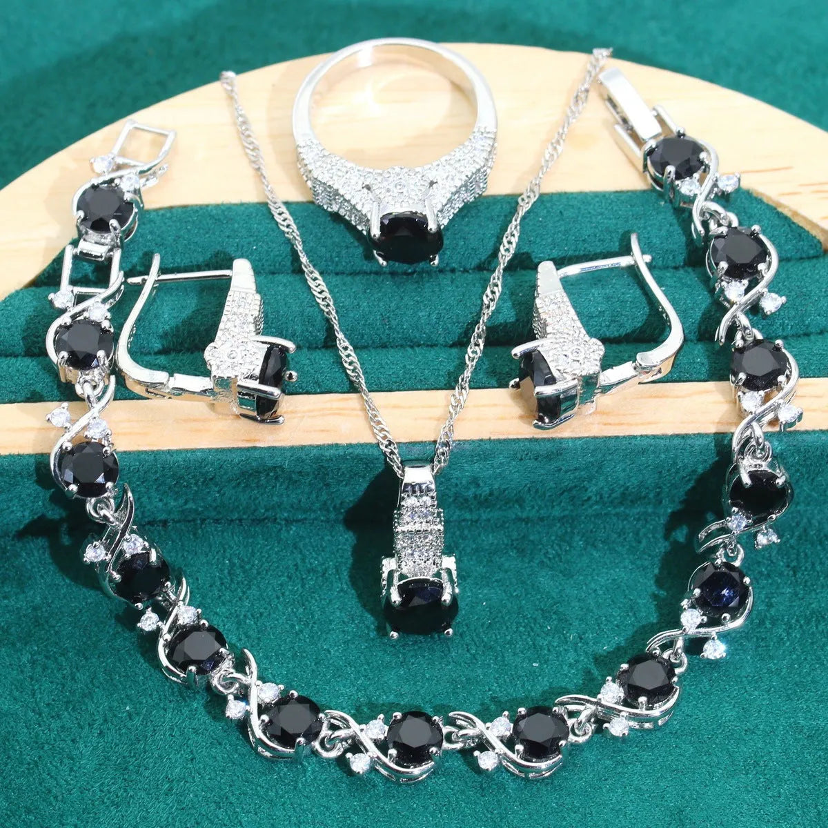 Bridal four-piece zircon jewellery set showing necklace, bracelet, earrings, and ring in alloy with water wave chain.