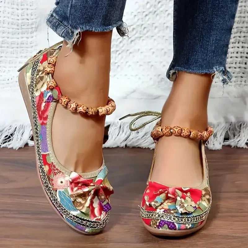 Women's black ethnic style platform sandals with cloth upper and elastic band fastening.