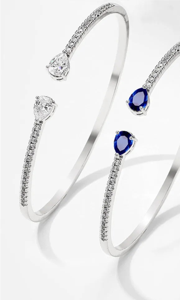 Copper bracelet with zircon inlay in simple design available in white or blue colour options