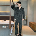 Men's black striped Ice Silk pajama set with long sleeves and trousers laid flat