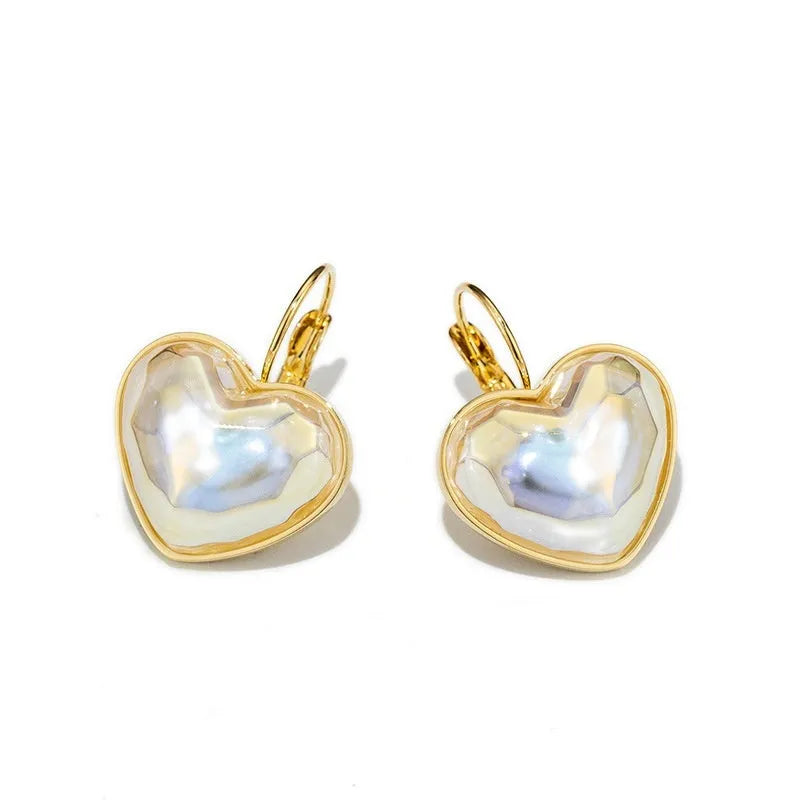 A pair of gold-coloured women's ear clips with a natural design on a white background.