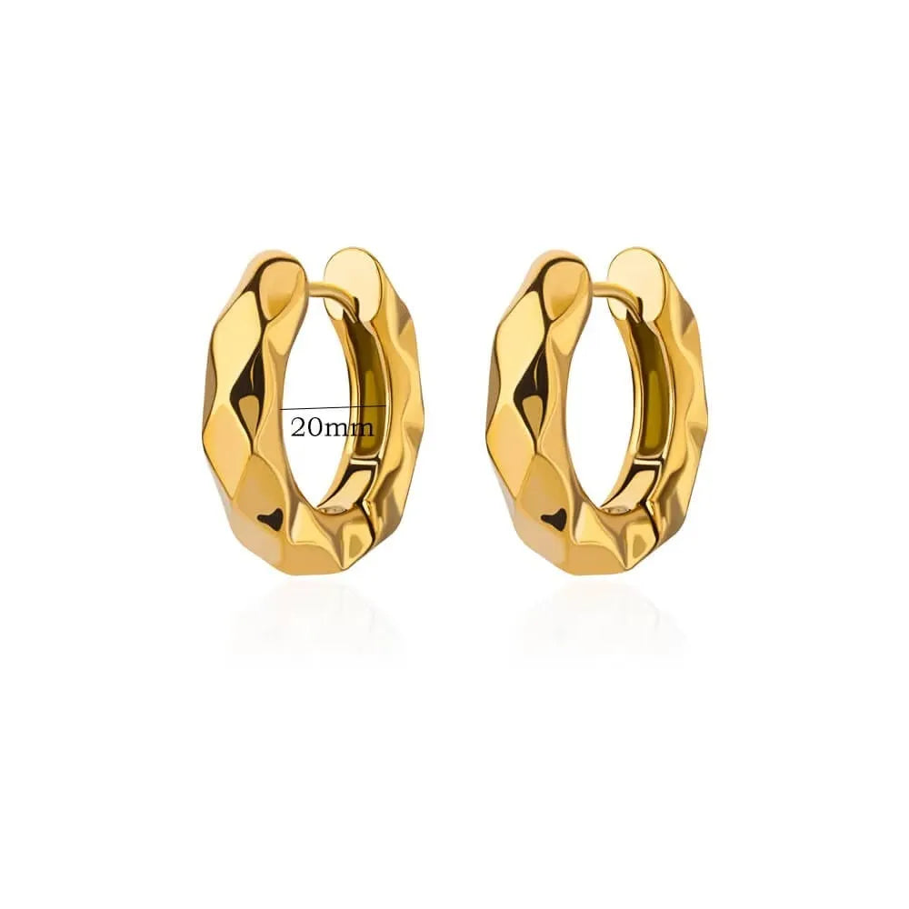 A pair of women's geometric butterfly earrings made from copper with heart, bow, and star shapes in a gold colour finish.