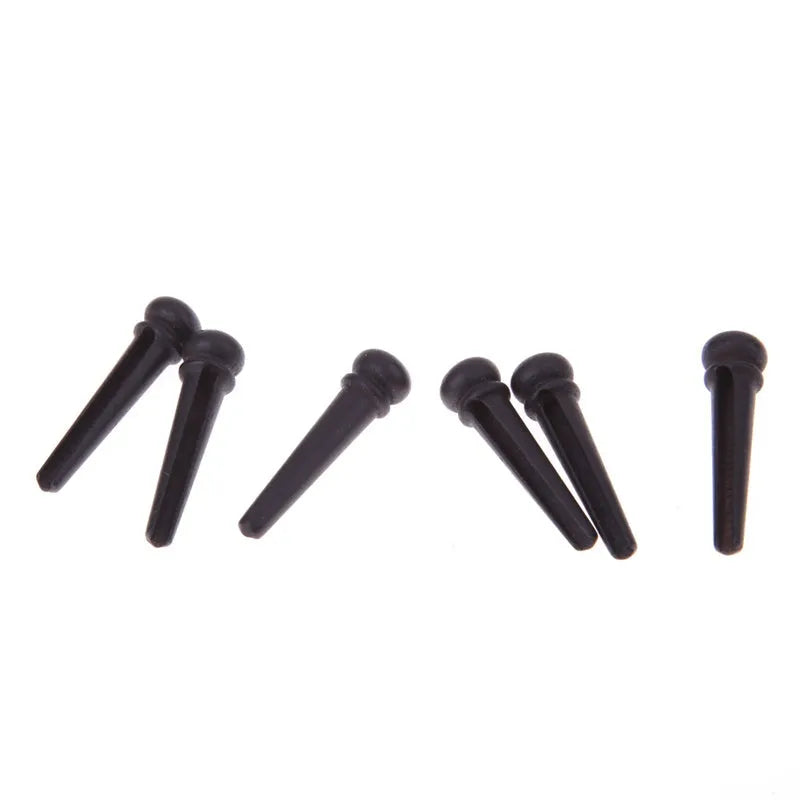 Six ebony folk guitar string nails with 5.3mm bayonet diameter and matt black finish