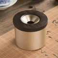Brass ashtray with wooden lid featuring centre hole design