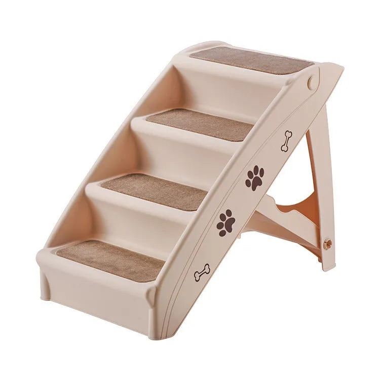 Foldable grey plastic pet stairs for small dogs and cats placed next to a sofa, showing non-slip mats on steps.