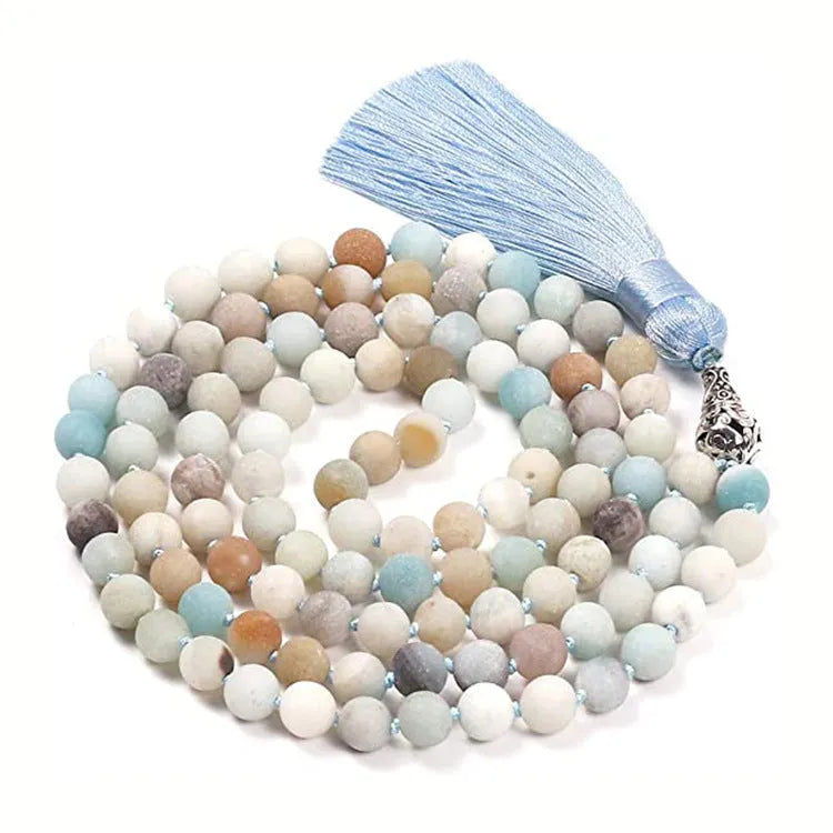 Geometric agate pendant necklace with colourful stone pattern and tassel detail on model