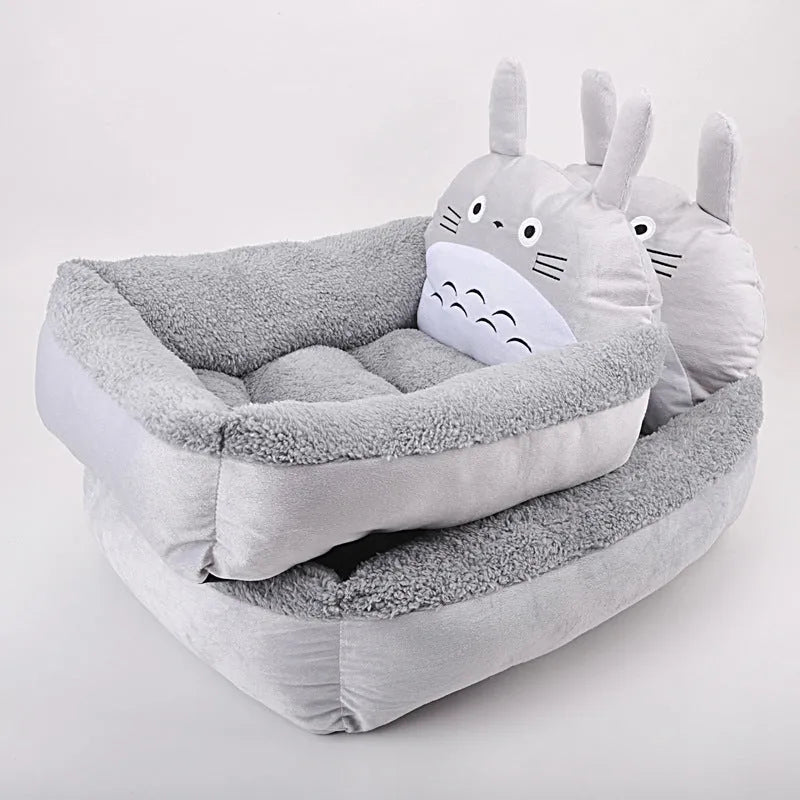 Blue cartoon-style pet bed sofa for a small dog, showing soft plush interior.