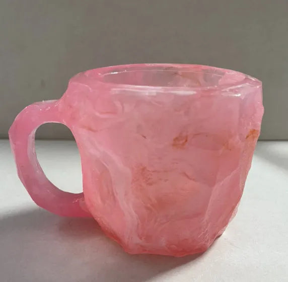Resin mineral crystal coffee mug with handle in purple colour, showing 3D texture.
