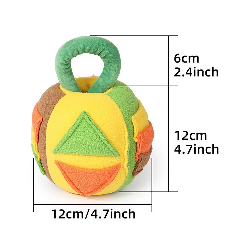 Green or pink polyester plush squeaky ball dog toy with treat pockets, shown next to a dog treat for scale.