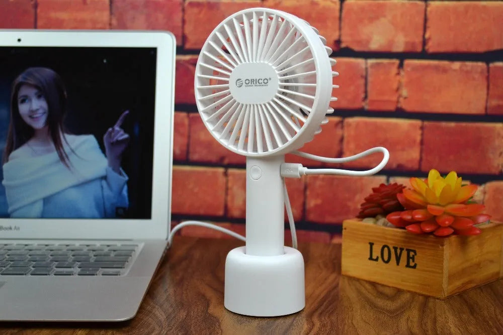 White ORICO FH1 portable USB rechargeable desk fan with three speed buttons and a compact design.