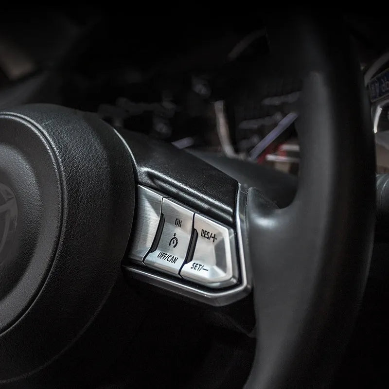 Atz aluminium alloy decorative stickers for car steering wheel buttons and interior trim, showing brushed metal and carbon fibre finishes.