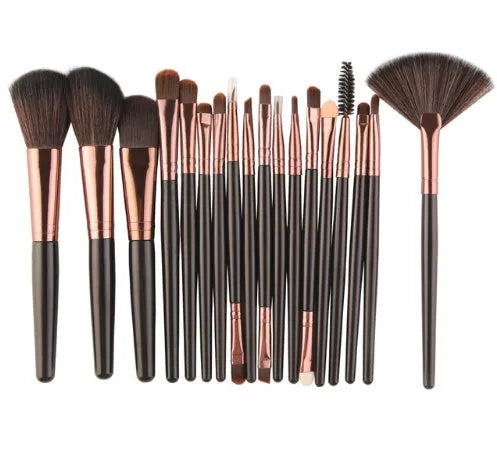 18-piece makeup brush set with a fan brush and assorted cosmetic brushes on a table.