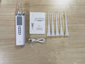 Milky white tonsil stone removal tool kit for oral hygiene, extractor tool on a plain background.