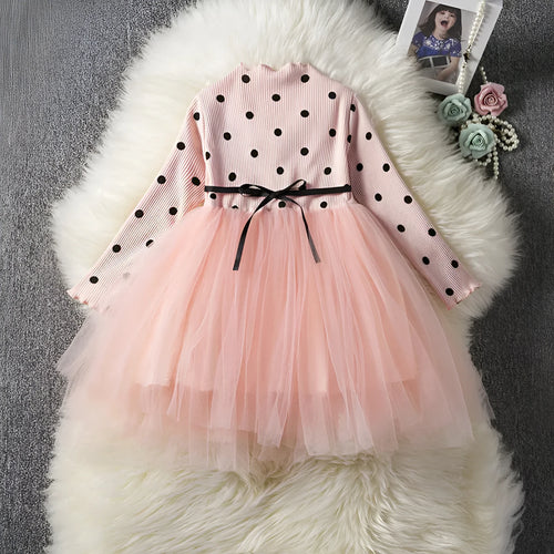 Baby girl wearing a long sleeve white lace tutu dress for a birthday party